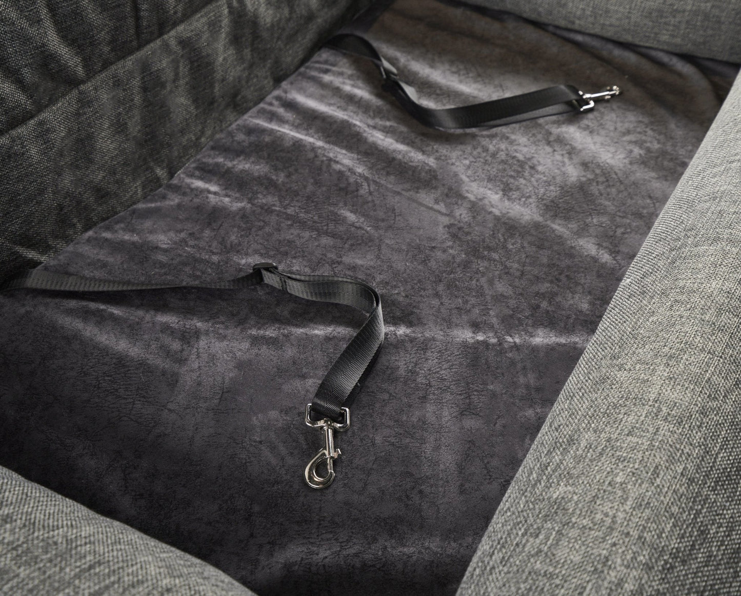 Gray fabric with a strap on a textured surface